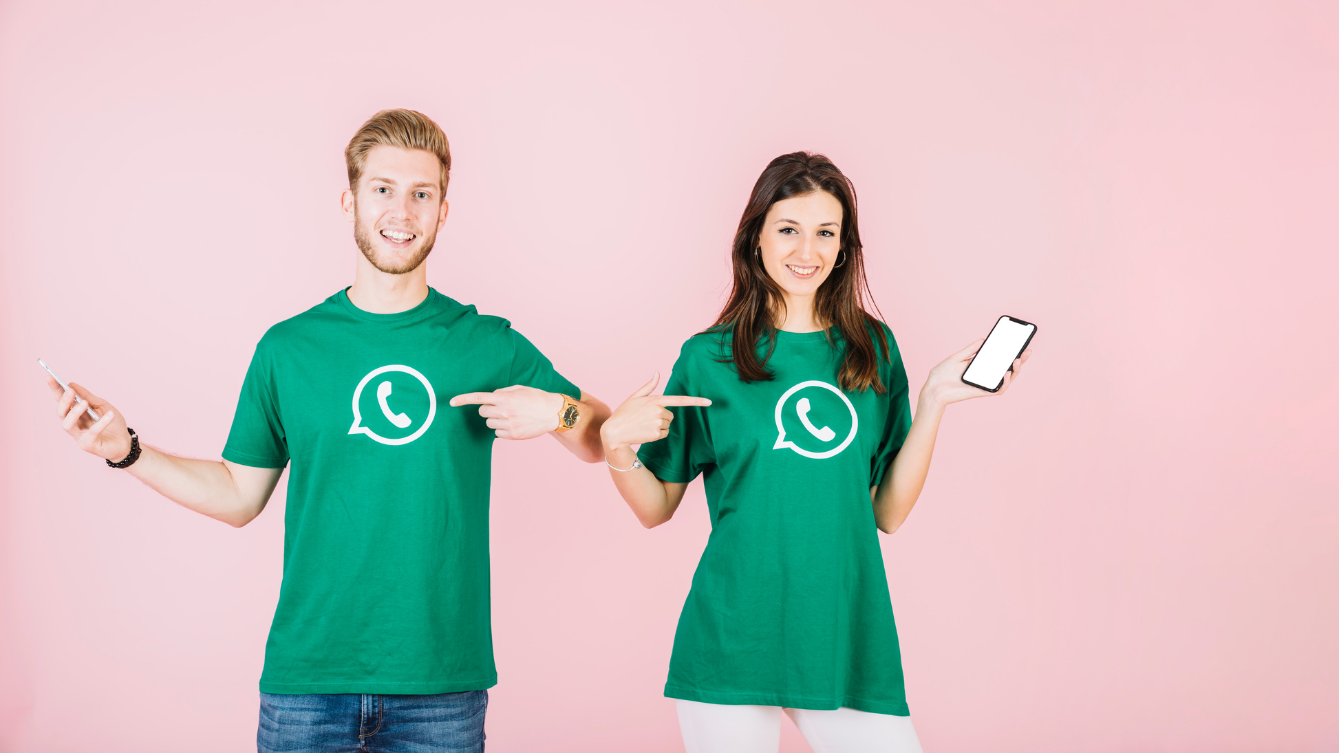 couple with cellphone pointing their t shirt with whatsapp i